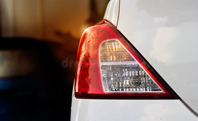 Back lights of white car after the rain on car parking stock photo Back lights of white car after the rain on car parking stock photo