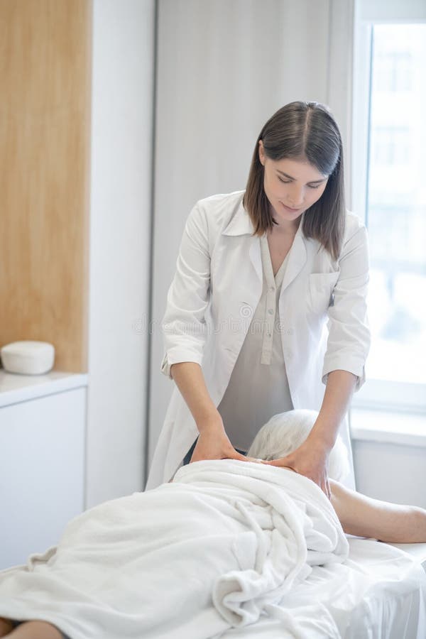 Female Massage Therapist Working With A Female Senior Patient Stock Image Image Of Medical