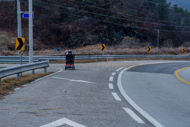 Motorized wheelchair on paved road