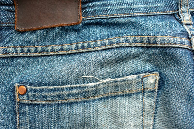 Back of Old Blue Jeans with Pocket and a Leather Tag. Close-up Photo ...