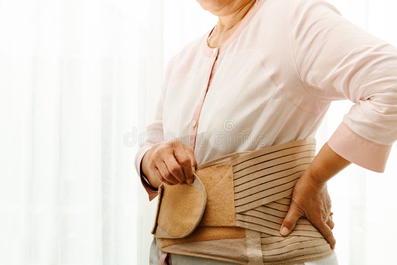 Back pain, senior woman wearing back support belt on white background royalty free stock photo Back pain, senior woman wearing back support belt on white background royalty free stock photo