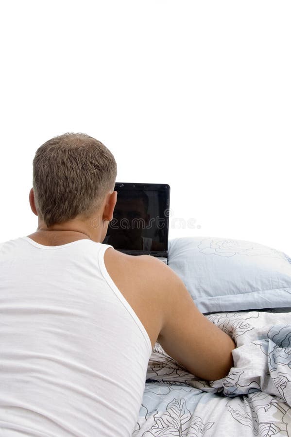 Back pose of laying man with laptop