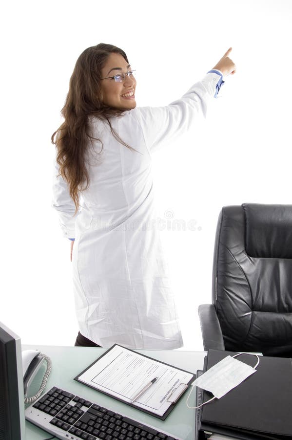 Back pose of young doctor pointing back side