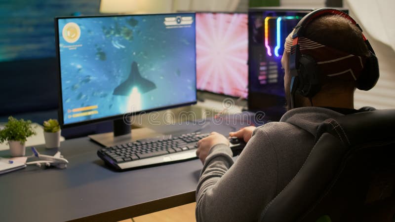 Person playing video games with controller on computer. Player using  joystick and wearing headphones to play online game on monitor. Modern man  using gaming equipment to have fun Stock Photo - Alamy