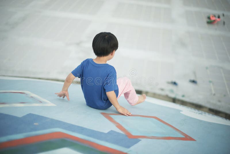 Back Side of Boy Going Down Park Slide stock images Back Side of Boy Going Down Park Slide stock images