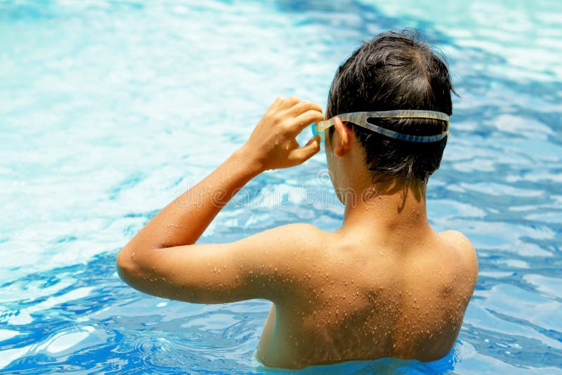 Back of teen boy at swimming pool