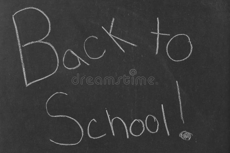 School Written on Vintage Chalkboard and a Chalk on the Board