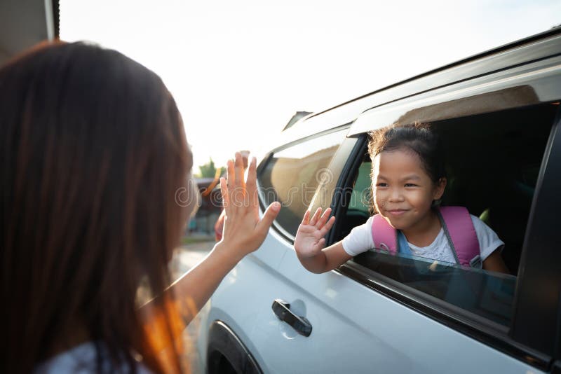 Asian Pupil Girl with Backpack Sitting in the Car Waving Goodbye To Her ...