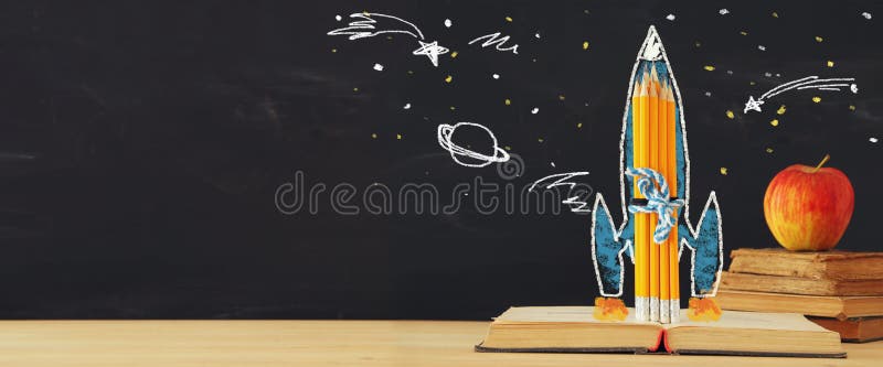 Back to school banner. rocket sketch and pencils over open book in front of classroom blackboard. royalty free stock photography Back to school banner. rocket sketch and pencils over open book in front of classroom blackboard. royalty free stock photography