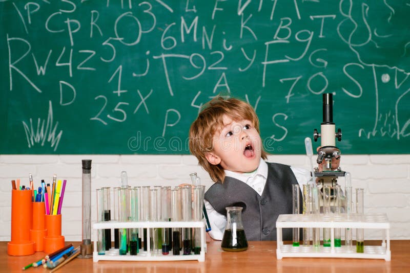 Back to school. Child in the class room with blackboard on background. Back to school and happy time. Happy smiling stock photos Back to school. Child in the class room with blackboard on background. Back to school and happy time. Happy smiling stock photos