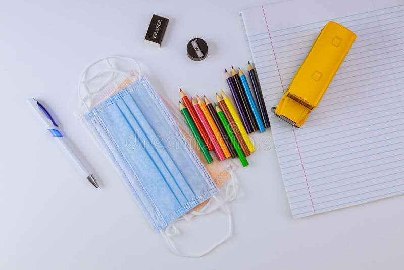 Back to school concept with bus school and notebook colored pencils safe coronavirus COVID-19 pandemic medical hygienic masks stock images Back to school concept with bus school and notebook colored pencils safe coronavirus COVID-19 pandemic medical hygienic masks stock images