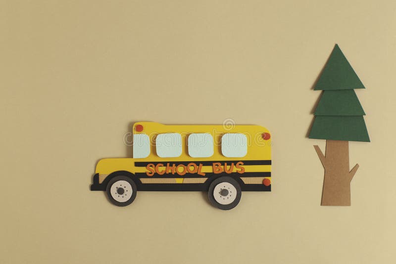 Back to school concept. Yellow bus with tree. Paper cutout artwork.