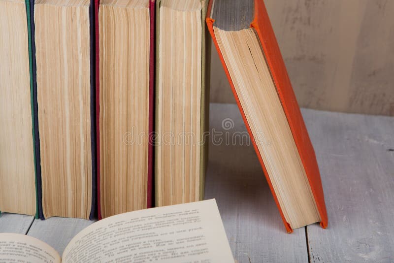 Back to school and education concept - heap colorful hardback books on white wooden table on brown background royalty free stock photos Back to school and education concept - heap colorful hardback books on white wooden table on brown background royalty free stock photos