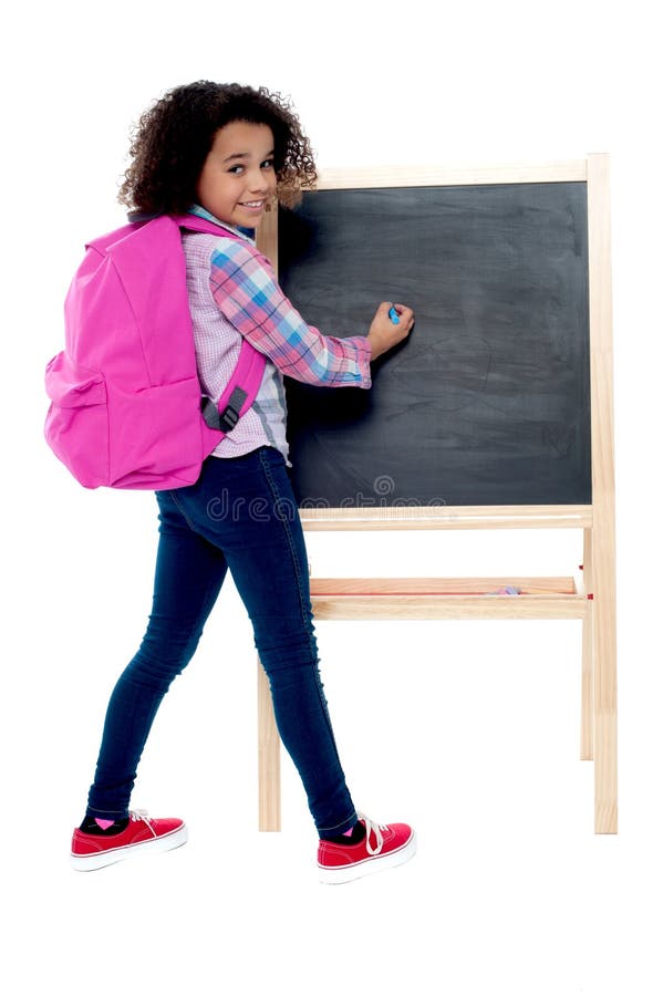 Back to school - little schoolgirl writing on blackboard