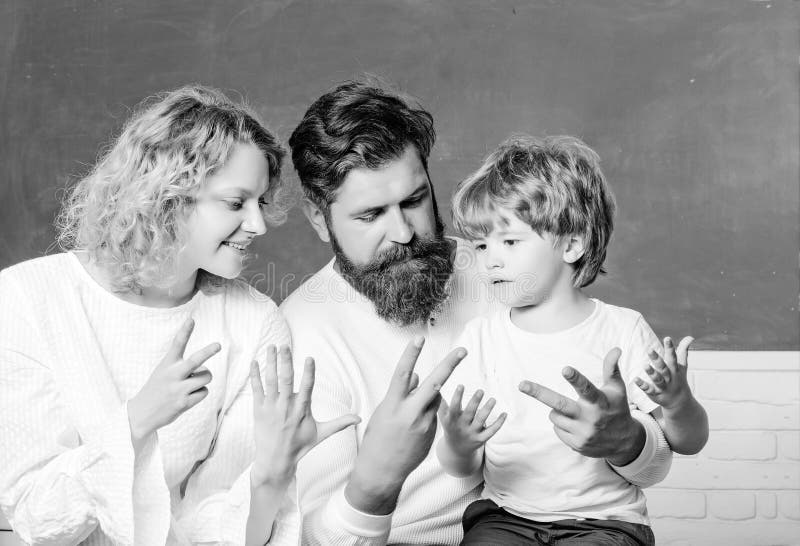 Back to school. School kids. Mother father and son together schooling. Pupil of primary school study indoors. royalty free stock photo Back to school. School kids. Mother father and son together schooling. Pupil of primary school study indoors. royalty free stock photo