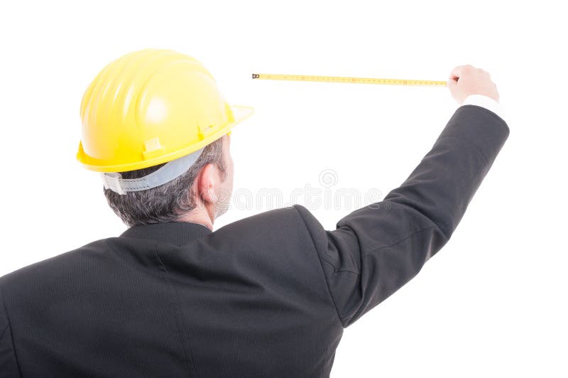 Back view of architect posing measuring with ruler tape stock photography