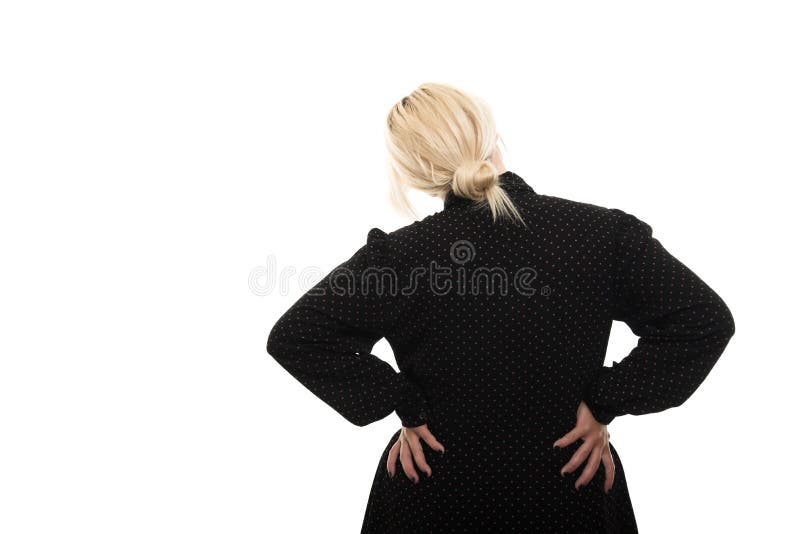 Back view of blonde female teacher showing back pain gesture stock photo Back view of blonde female teacher showing back pain gesture stock photo