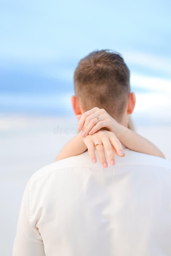 Back view of caucasian female hands holding man neck. royalty free stock images