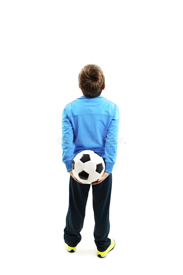 Back view of a child in sportswear holding a soccer ball