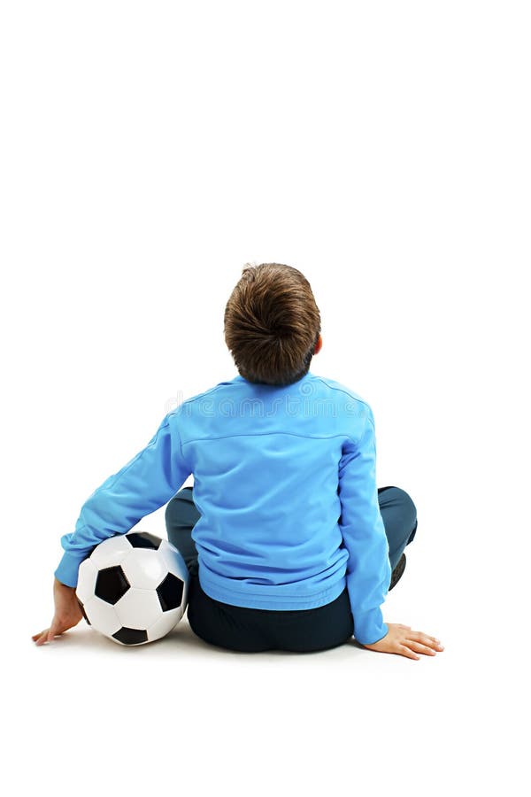 Back view of a child in sportswear with soccer ball