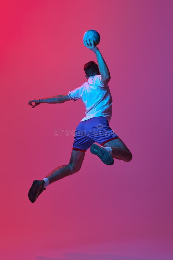Back View. Dynamic Studio Shot of Professional Male Handball Player in