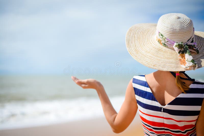 Back view of elegant woman holding hand palm up with summer sea on the background royalty free stock photos Back view of elegant woman holding hand palm up with summer sea on the background royalty free stock photos