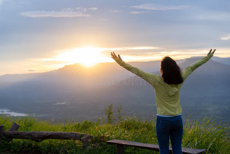 Back view. Freedom traveler teenage standing with raised arms and enjoying blue sky at sunset beautiful. Phu Pa PO or Fuji Loei of. Thailand royalty free stock photos Back view. Freedom traveler teenage standing with raised arms and enjoying blue sky at sunset beautiful. Phu Pa PO or Fuji Loei of. Thailand royalty free stock photos