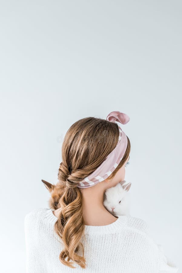 Back view of girl holding adorable furry rabbits royalty free stock photography Back view of girl holding adorable furry rabbits royalty free stock photography