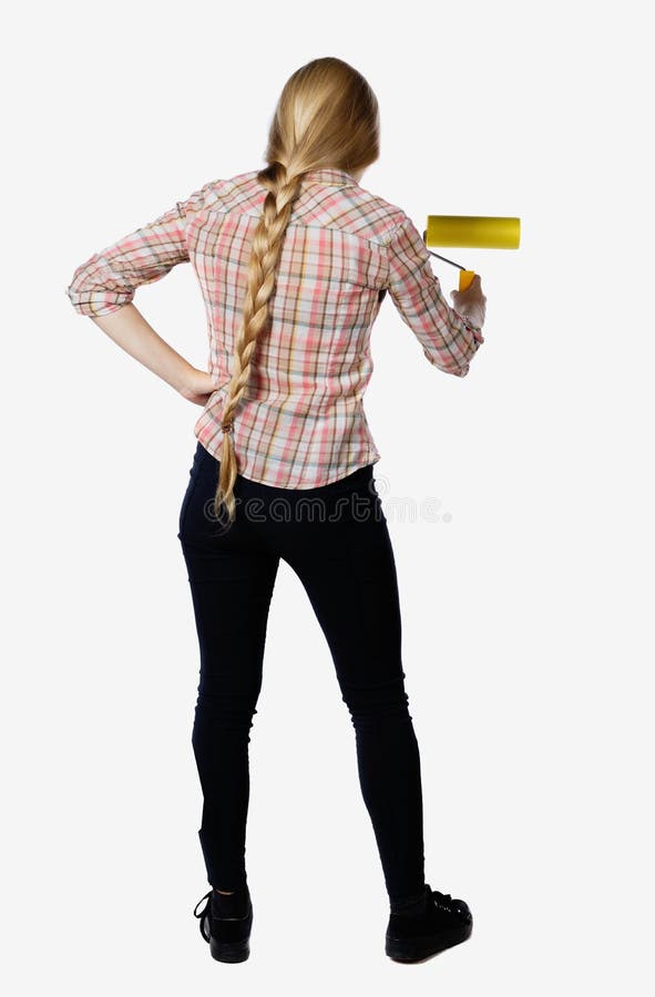 Back view of a girl who paints the paint roller. rear view people collection. backside view of person. Isolated over white background. Put his hand into the side of the girl paints a wall