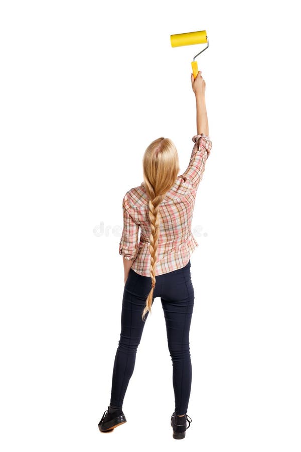 Back view of a girl who paints the paint roller. rear view people collection. backside view of person. Isolated over white background. Blonde girl in a checkered shirt paints the wall.