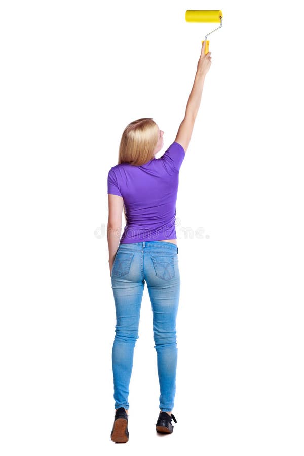 Back view of a girl who paints the paint roller. rear view people collection. backside view of person. Isolated over white background. Long-haired blonde in the purple shirt top paint roller.