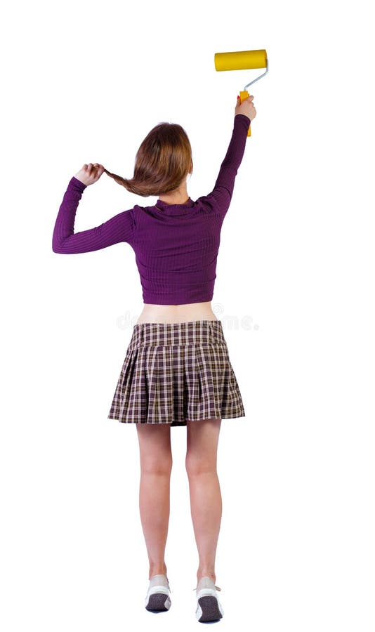 Back view of a girl who paints the paint roller. rear view people collection. backside view of person. Isolated over white background. Playful girl paints a wall