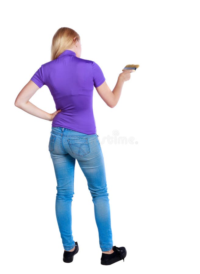 Back view of a girl who paints the paint roller. rear view people collection. backside view of person. Isolated over white background. Long-haired blonde in the purple shirt color brush.