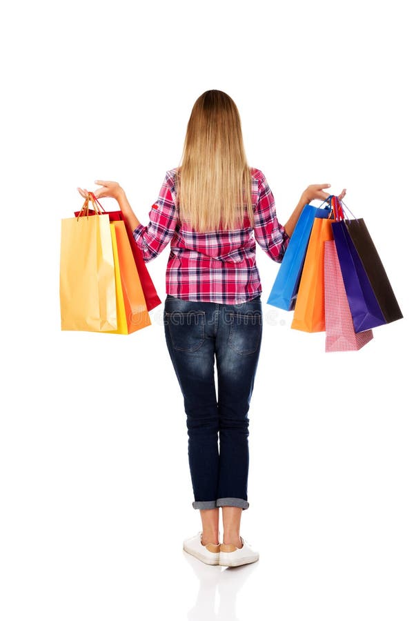 Back view of going woman with shopping bags stock photos