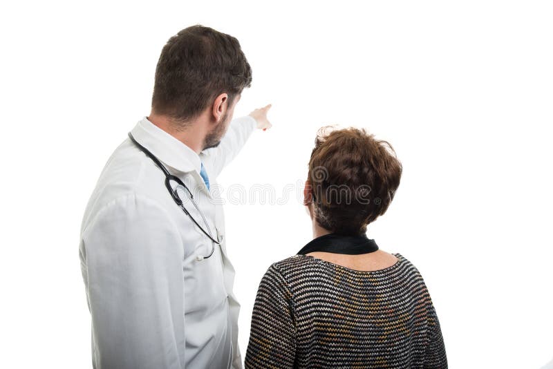 Back view of male doctor pointing to female senior patient royalty free stock photography Back view of male doctor pointing to female senior patient royalty free stock photography
