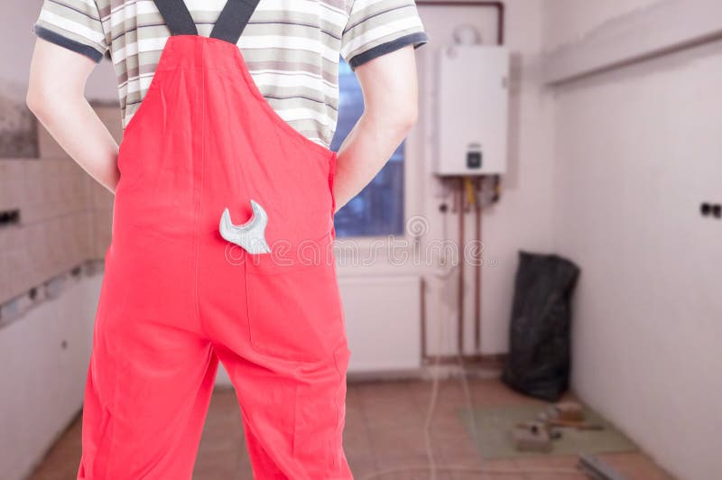 Back view of male fitter holding spanner stock photo