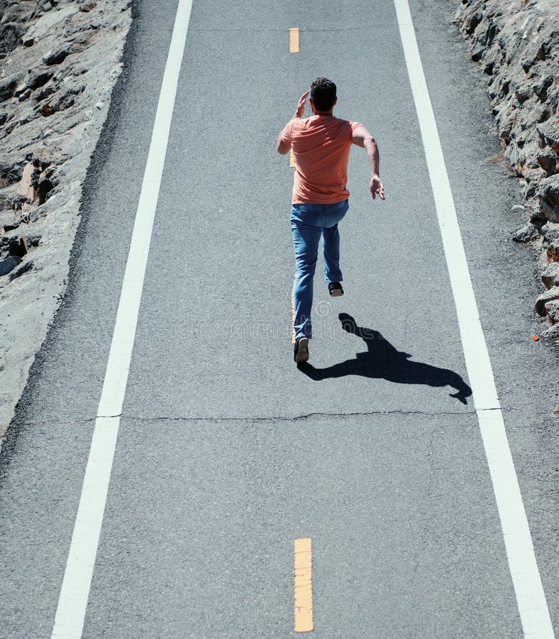 Back View of Man Running on the Road. Athletic Young Man Running