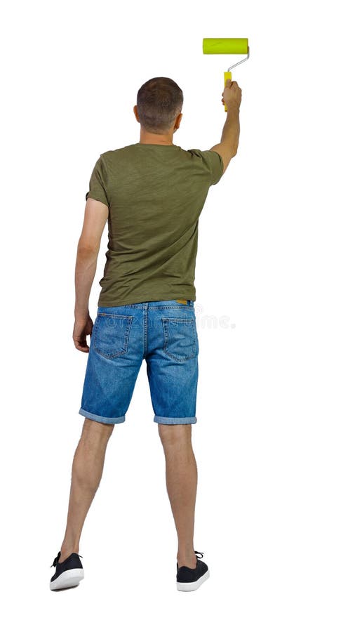 Back view of a man who paints the paint roller. rear view people collection. backside view of person. Isolated over white background