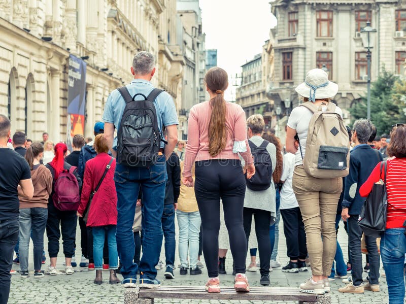 Back view with many people audience at astreet performance in the old town center of Bucharest, Romania royalty free stock photos