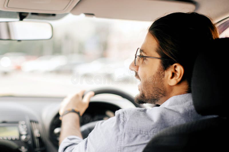 Back view of middle-eastern guy driving auto royalty free stock photos