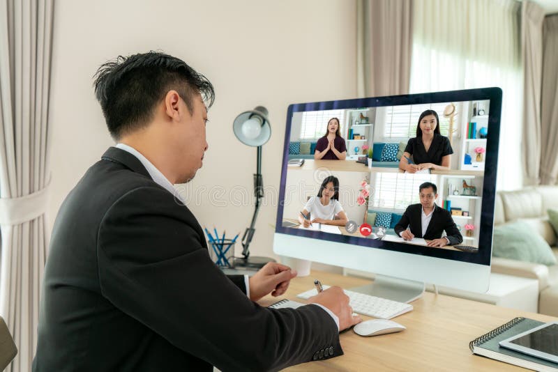 Back view of Mixed race business man talking to his colleagues about plan in video conference. Multiethnic business team using stock photography