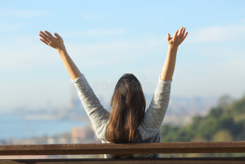 Happy woman raising arms looking at horizon royalty free stock photo Happy woman raising arms looking at horizon royalty free stock photo