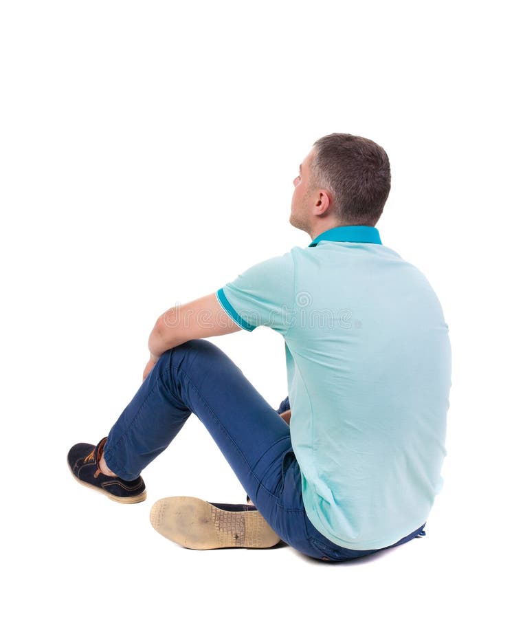 Back view of seated handsome man in polo looking up.