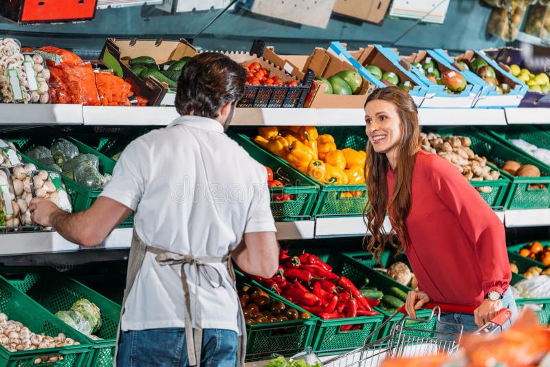 back view of shop assistant in apron and female shopper royalty free stock images back view of shop assistant in apron and female shopper royalty free stock images