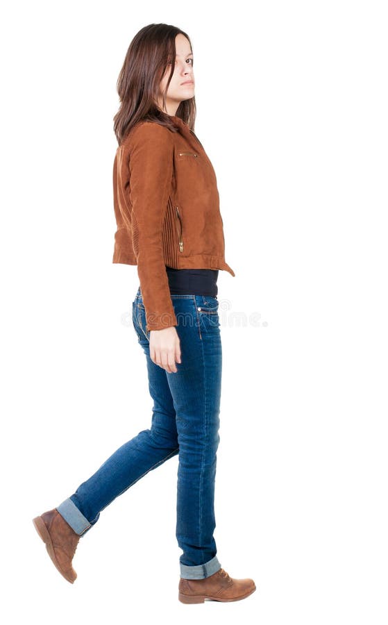 Back view of walking woman in brown jacket.