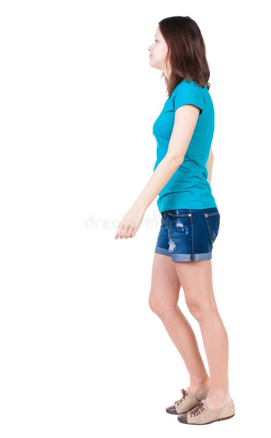 Back view of walking woman in shorts.