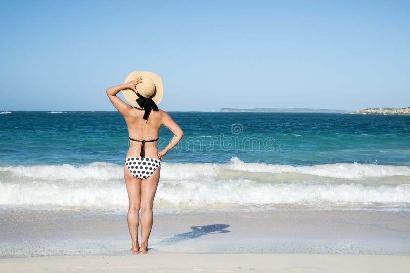 Back View of a Woman in Polka Dot Bikini Standing on a Beach 2