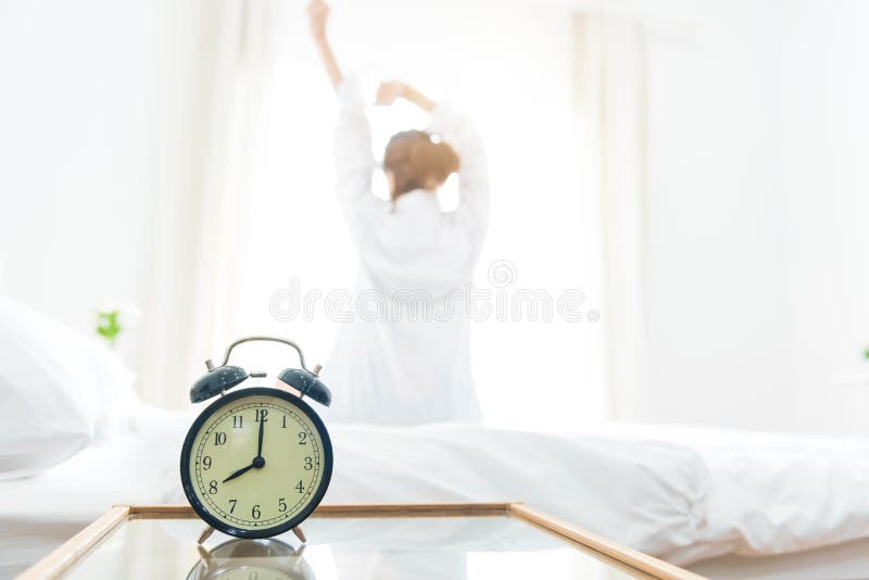 Back view of woman stretching in morning after waking up on bed stock photography Back view of woman stretching in morning after waking up on bed stock photography