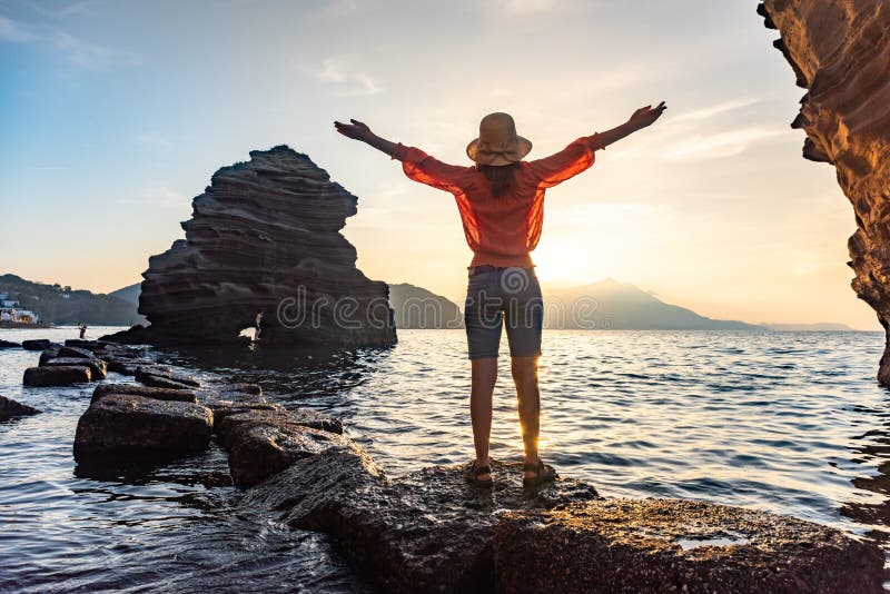 back view of young girl over sea sunset on Amalfi coast. Travel, relax, vacation