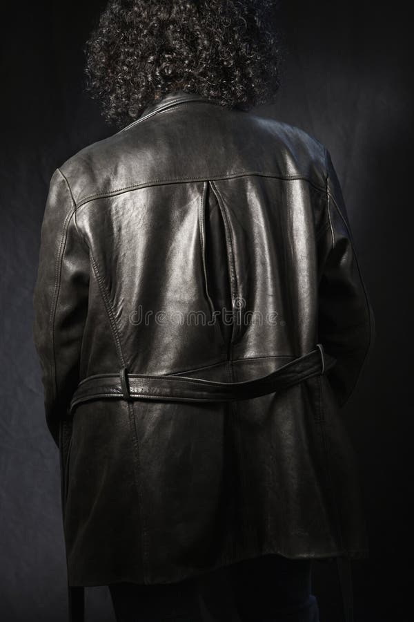 Back of woman in leather coat.